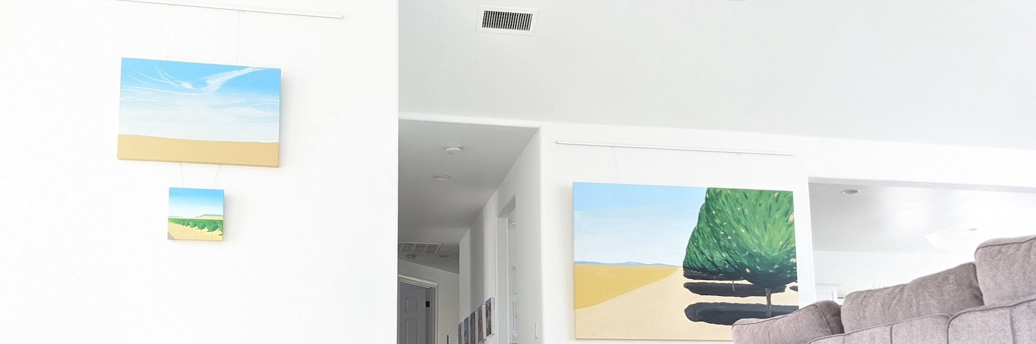Home interior equipped with picture hanging systems in several locations, being used to display beautiful landscape paintings