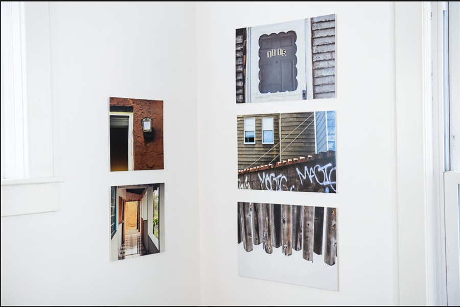 Closeup of small artfully arranged grouping of photographs in corner of living room