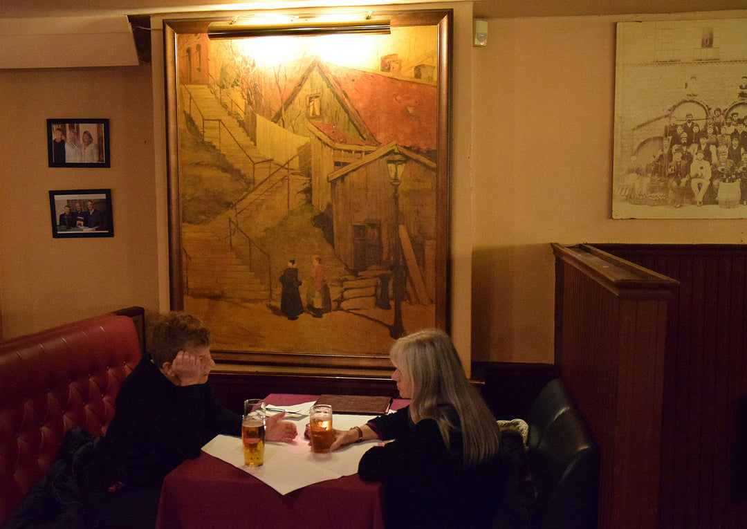 art display in restaurant with picture light in place