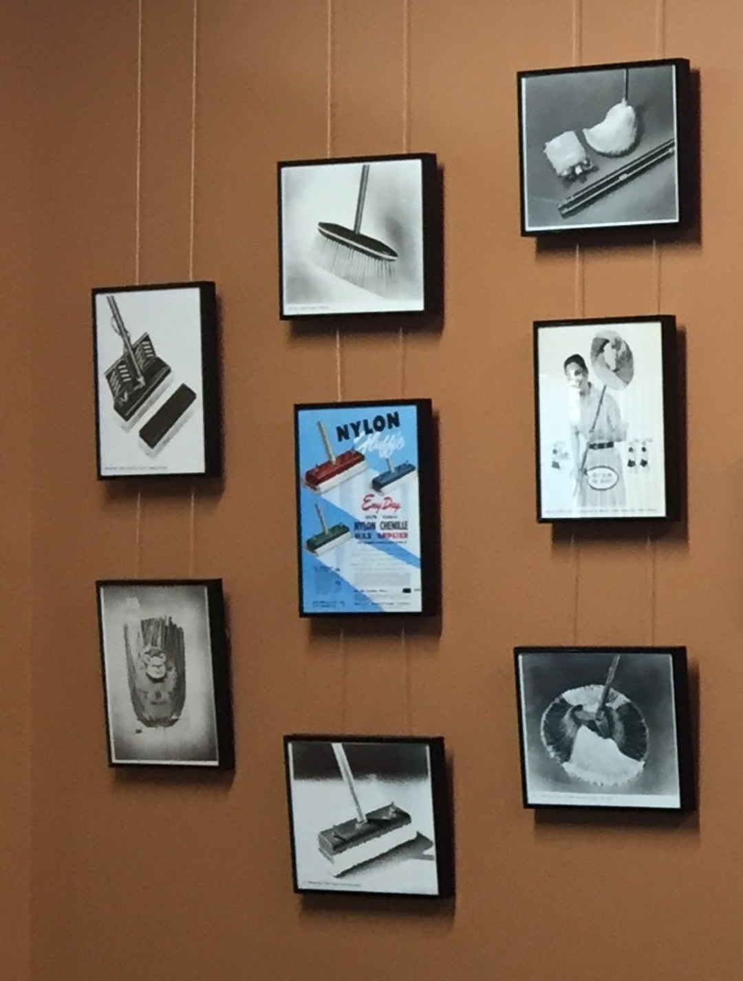 corrected display of vintage advertisements and photos displayed straight and evenly on a picture hanging system 
