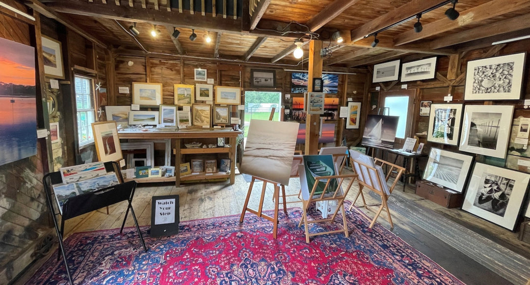 panoramic view of rustic barn art gallery equipped with art hanging system on all walls