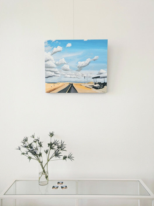 Closeup of home interior showing landscape painting hung on picture hanging system