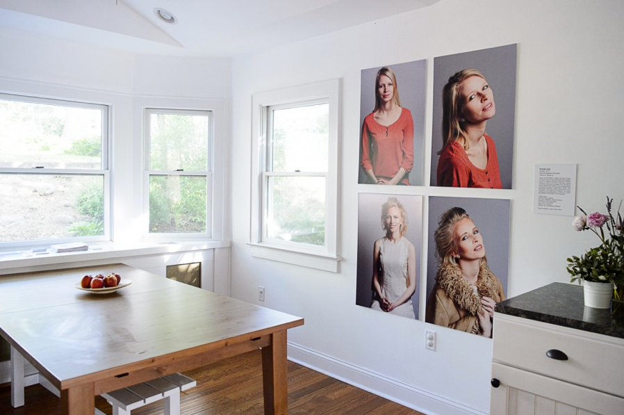 Group of four photo portraits of the same person arranged in a square pattern on a kitchen gallery wall