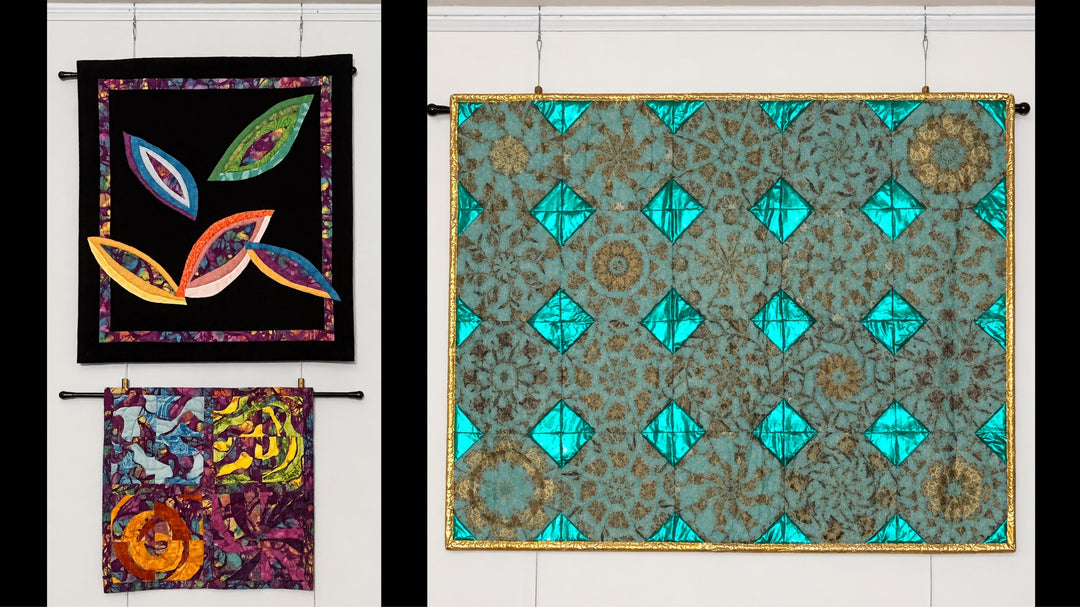 Colorful quilts hung on picture rail molding using adjustable looped cable picturerail hangers