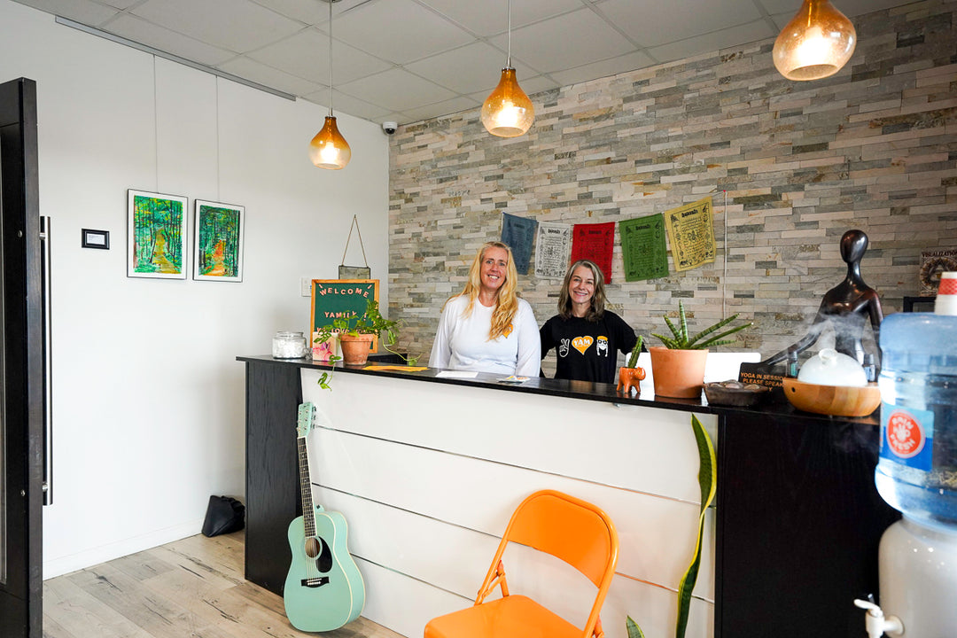 Front desk of YAM Dallas, with art displayed on wall using a picture hanging system 