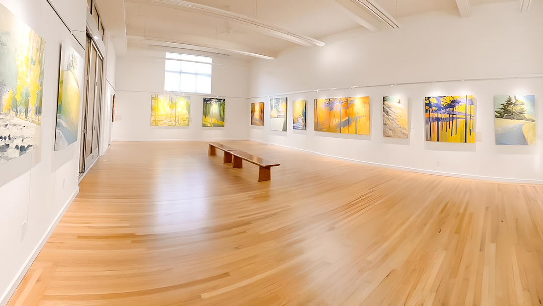 spare modernist art gallery showing large paintings hung on picture hanging system with integrated art lighting 