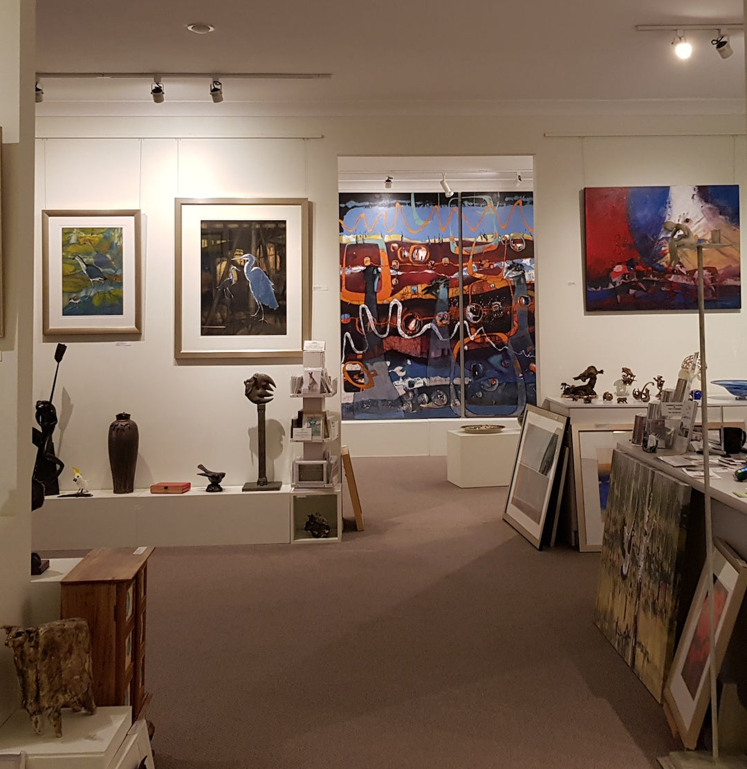 art gallery interior, showing exhibits including paintings hung on wall mounted picture hanging systems