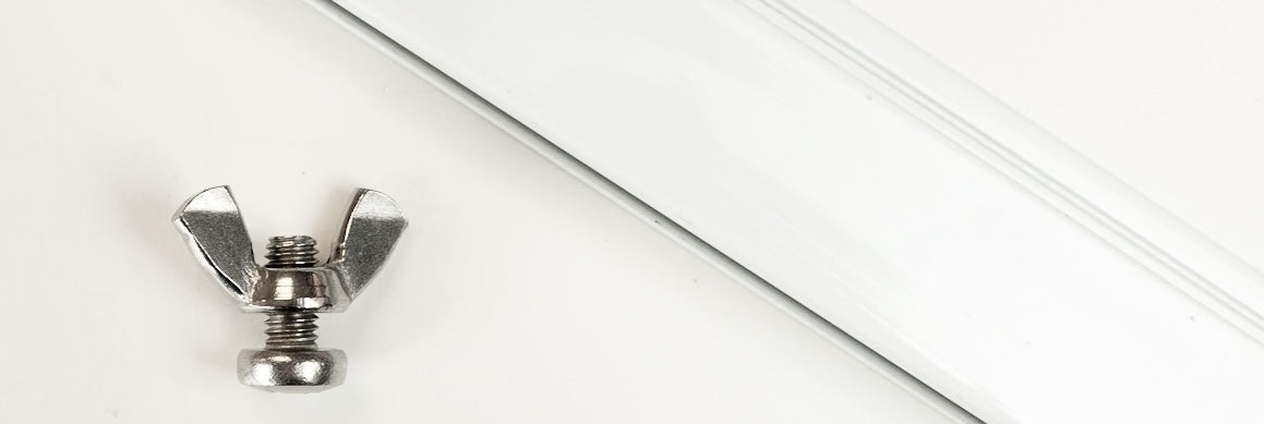 wall track of a picture hanging system mounted at an angle, with short bolt and wing nut in foreground