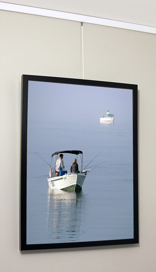 Clearline picture hanging system being used to hang photo of boat
